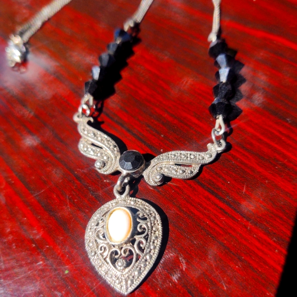Black and silver necklace with white opal...